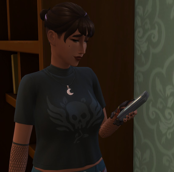 A Sims 4 screenshot, A teenage Ajei, who has short, buzzed hair on the bottom, with the top put into a tiny bun, purple highlights, and a black skull tshirt with mesh gloves and black nails.